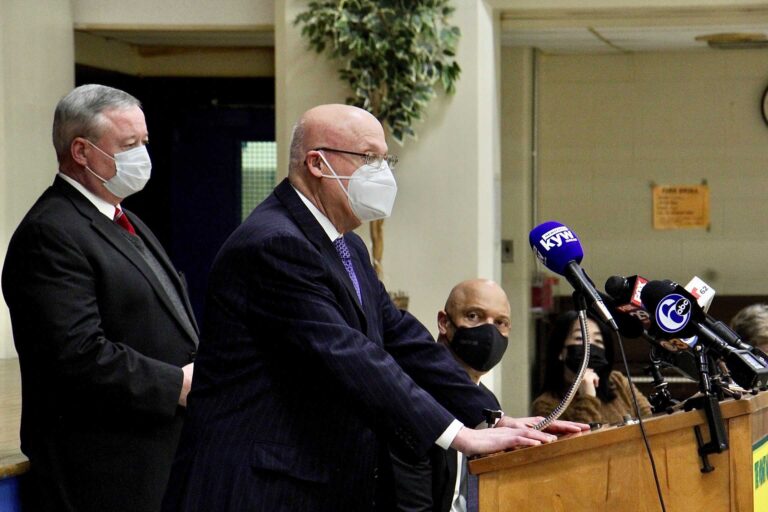 AFT Pennsylvania President Arthur Steinberg speaks at a podium beside Mayor Jim Kenney, with Superintendent William Hite in the background