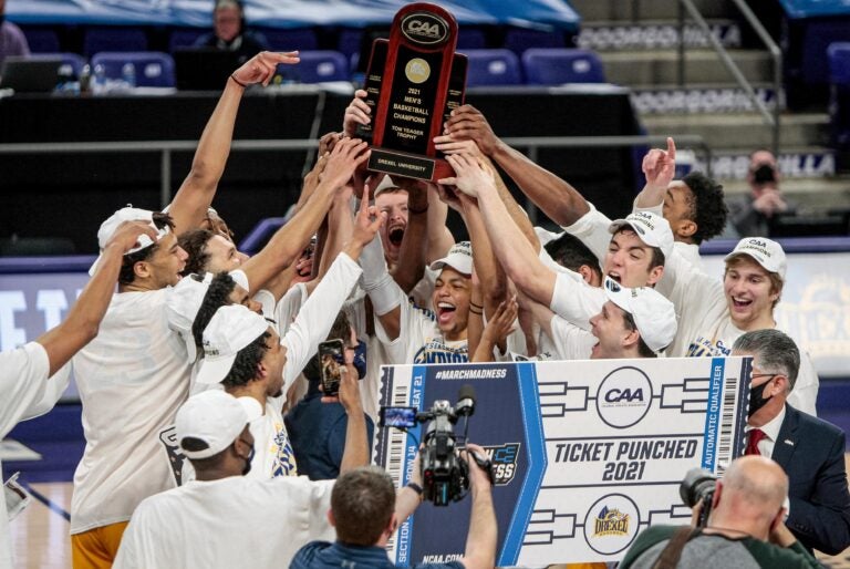 Drexel celebrates after a win over Elon in an NCAA college basketball game for the Colonial Athletic Association men's tournament championship in Harrisonburg, Va., Tuesday, March 9, 2021. (AP Photo/Daniel Lin)