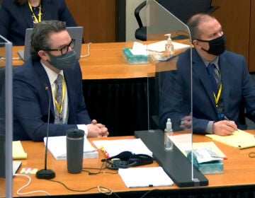 In this image taken from video, defense attorney Eric Nelson, left, and defendant, former Minneapolis police officer Derek Chauvin, right, listen to Hennepin County Judge Peter Cahill during pretrial motions, prior to continuing jury selection in the trial of Chauvin, Thursday, March 11, 2021, at the Hennepin County Courthouse in Minneapolis, Minn. (Court TV/Pool via Pool)