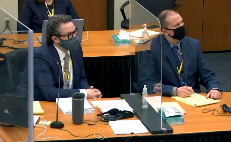 In this image taken from video, defense attorney Eric Nelson, left, and defendant, former Minneapolis police officer Derek Chauvin, right, listen to Hennepin County Judge Peter Cahill during pretrial motions, prior to continuing jury selection in the trial of Chauvin, Thursday, March 11, 2021, at the Hennepin County Courthouse in Minneapolis, Minn. (Court TV/Pool via Pool)