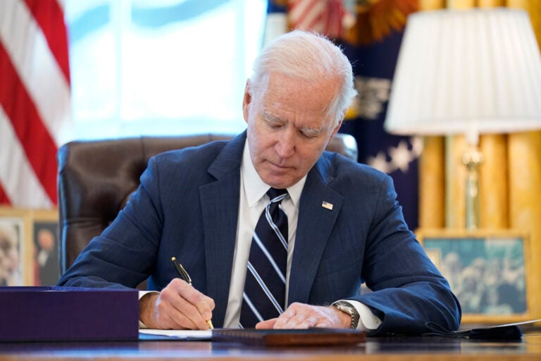 President Joe Biden signs the American Rescue Plan, a coronavirus relief package, in the Oval Office of the White House, Thursday, March 11, 2021, in Washington. (AP Photo/Andrew Harnik)