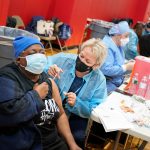 Mary Jenkins, left, received the COVID-19 vaccine in Paterson, N.J., Thursday, Jan. 21, 2021. (AP Photo/Seth Wenig)