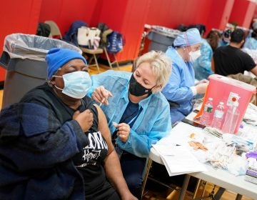 Mary Jenkins, left, received the COVID-19 vaccine in Paterson, N.J., Thursday, Jan. 21, 2021. (AP Photo/Seth Wenig)