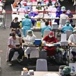 A journalist receives a shot of China's Sinovac COVID-19 vaccine