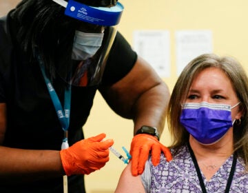 Nurse Monique Bourgeois, left, administers the Johnson & Johnson COVID-19 vaccine to educator Diane Kay at a vaccination site set up setup for teachers and school staff at the Berks County Intermediate Unit in Reading, Pa., Monday, March 15, 2021. (AP Photo/Matt Rourke)