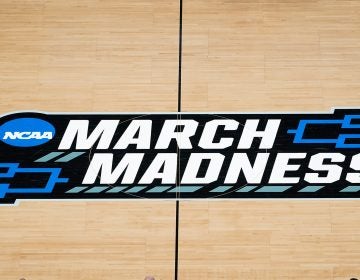 The March Madness logo is shown on the court