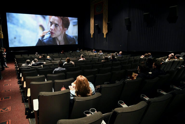 Moviegoers sitting in a socially distant seating arrangement at the AMC Lincoln Square 13 theater