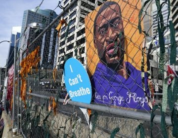 A picture of George Floyd hangs on a fence outside Hennepin County Government Center