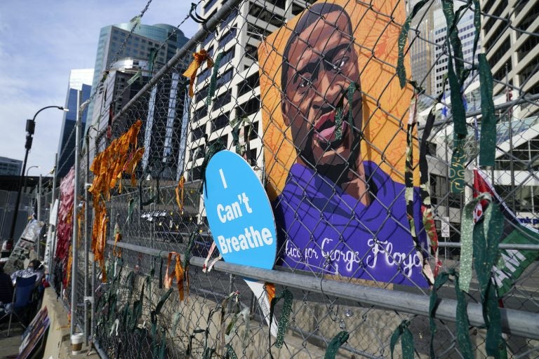 A picture of George Floyd hangs on a fence outside Hennepin County Government Center