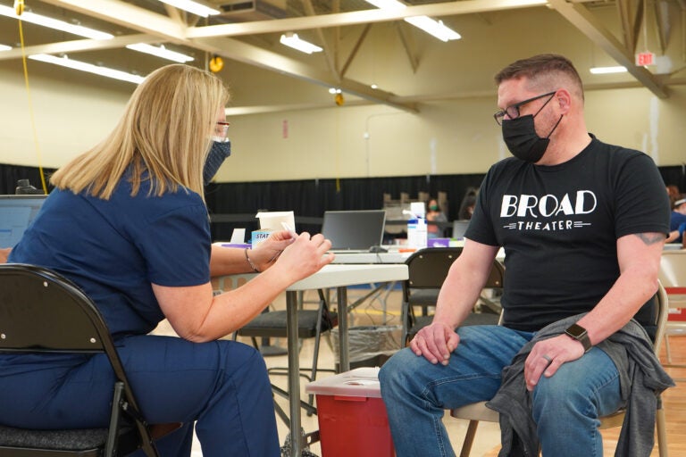 Randy Loux, 48, is getting prepped for his COVID vaccine at the new Willow Grove site. (Kenny Cooper/WHYY)