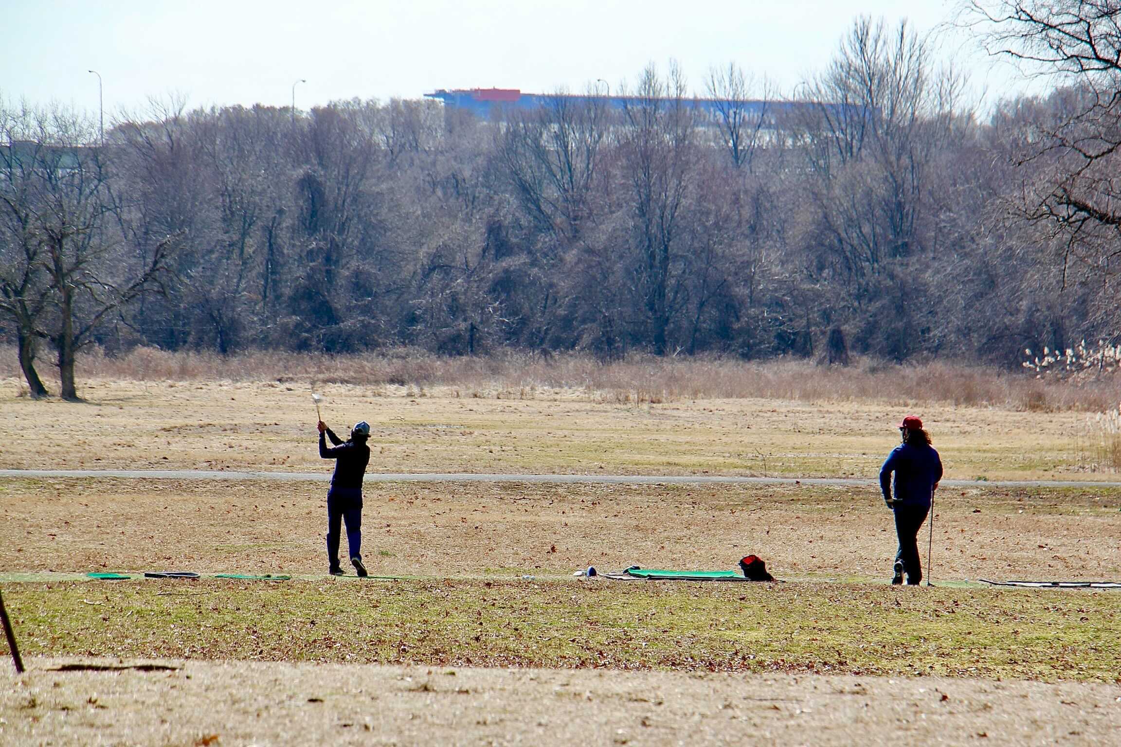 Golfers work on their swings at the abandoned FDR Park golf course