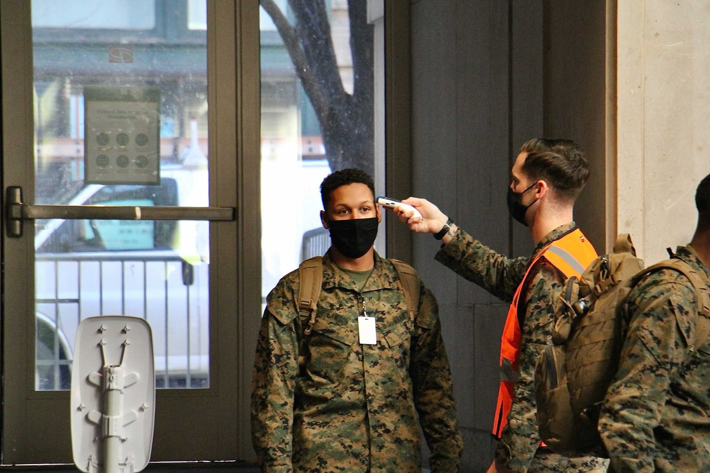 National Guard members undergo a temperature check as they enter the Pennsylvania Convention Center