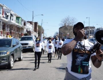 Fareed Abdullah leads a peace march against gun violence in Southwest Philadelphia on March 20, 2021. (Kenny Cooper/WHYY)