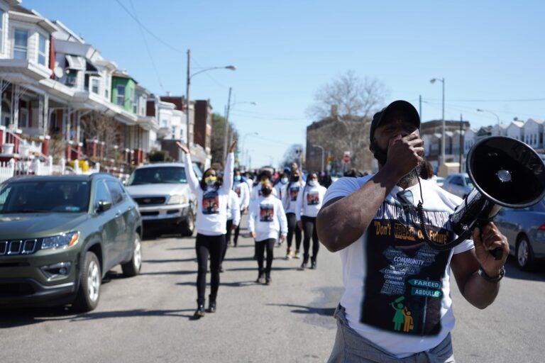 Fareed Abdullah leads a peace march against gun violence in Southwest Philadelphia on March 20, 2021. (Kenny Cooper/WHYY)
