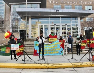 Members of Juntos rally in front of the Philadelphia schools administration building calling for the district to support immigrant students and their families. (Emma Lee/WHYY)