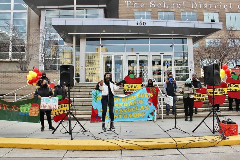 Members of Juntos rally in front of the Philadelphia schools administration building calling for the district to support immigrant students and their families. (Emma Lee/WHYY)