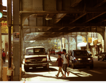 People crossing the street under the El in Kensington.