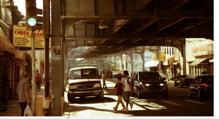 People crossing the street under the El in Kensington.