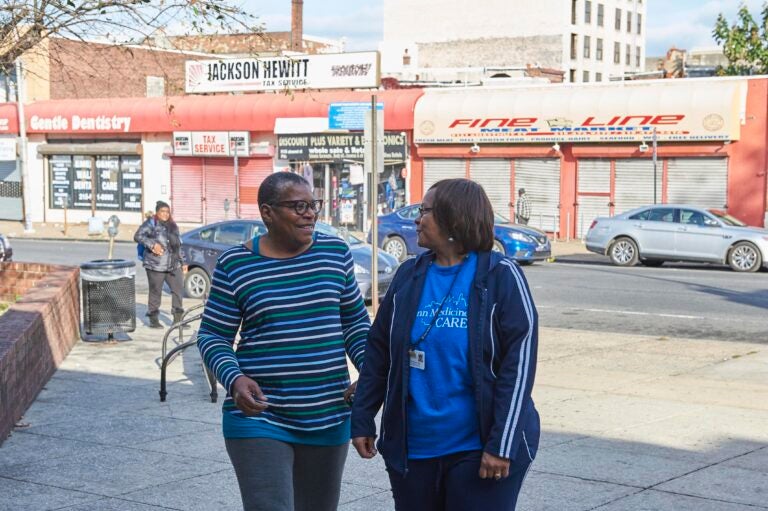 West Philadelphia resident Phyllis Carter (left) takes a walk with her community health worker