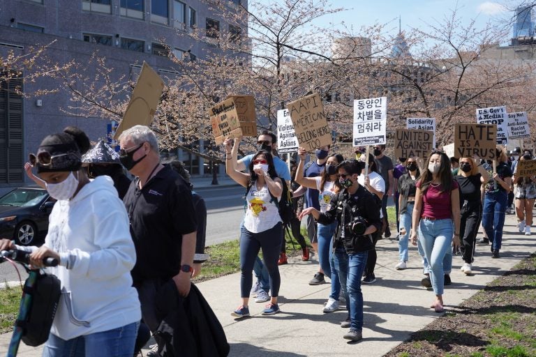 Protesters march west on Sixth Street during a rally against anti-Asian violence in Philadelphia on March 27, 2021. (Kenny Cooper/WHYY)