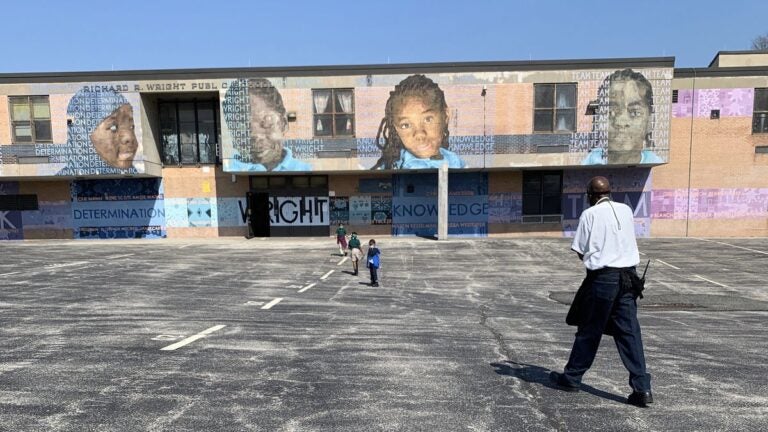 Climate specialist Charles Brown gets students back to class after recess at Richard Wright Elementary School in North Philadelphia. (Dale Mezzacappa/Chalkbeat Philadelphia)