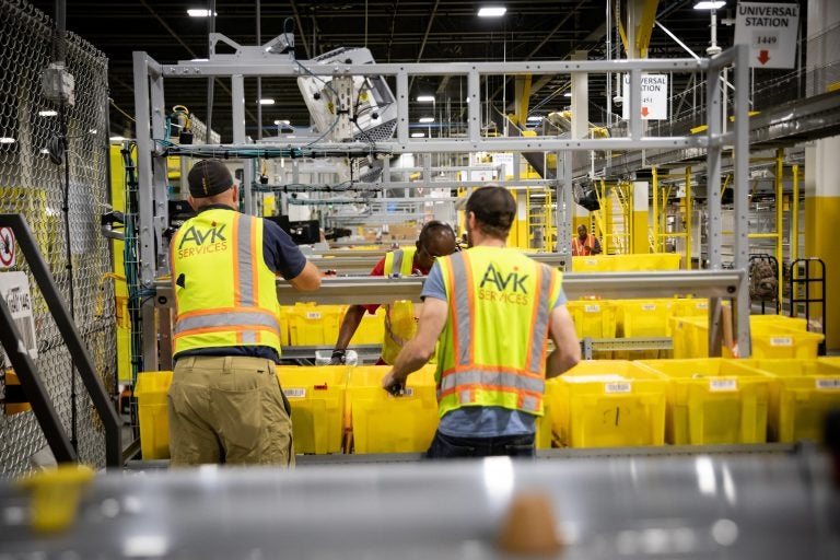 Employees work inside an Amazon fulfillment center