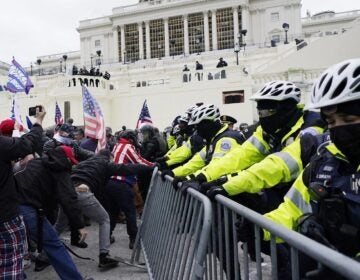 Trump supporters try to break through a police barrier, Wednesday, Jan. 6, 2021, at the Capitol in Washington. As Congress prepares to affirm President-elect Joe Biden's victory, thousands of people have gathered to show their support for President Donald Trump and his claims of election fraud.