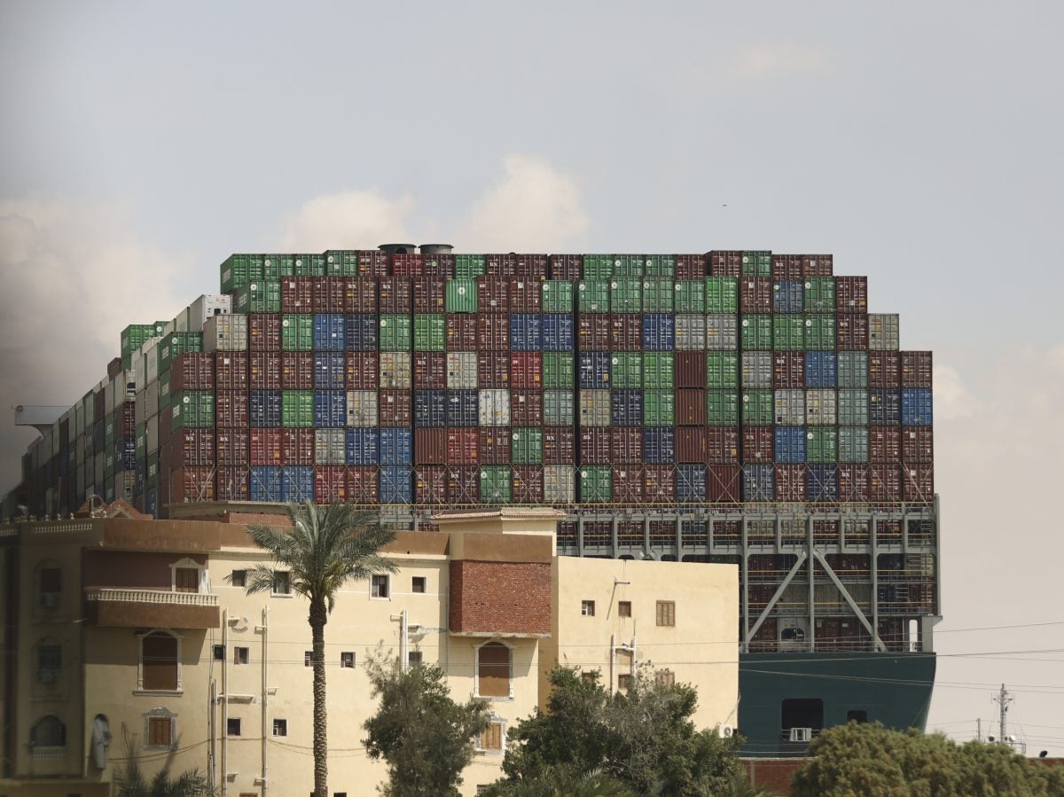 The Panama-flagged Ever Given is seen wedged across the Suez Canal on Friday. Tugboats, dredgers and even land-based, earth-moving equipment have been pressed into service to try to free the 1,300-foot container ship.