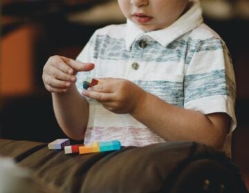 Young child plays with Legos.