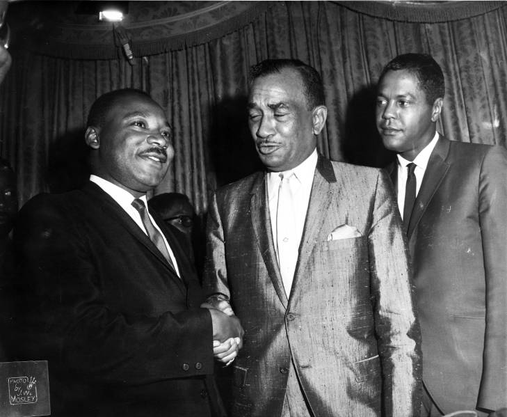 Dr. Martin Luther King Jr. and Cecil B. Moore shake hands as Georgie Woods watches in 1965 at the Bellevue-Stratford Hotel in Philadelphia. (Courtesy of Temple University Libraries, Charles L. Blockson Afro-American Collection)