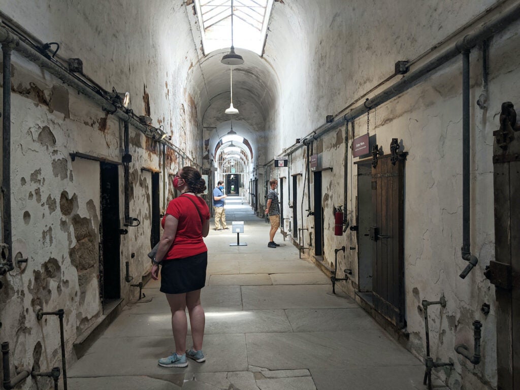 Visitors explore cellblocks at Eastern State Penitentiary.