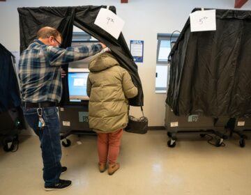 A person enters the voting booth to cast their ballot