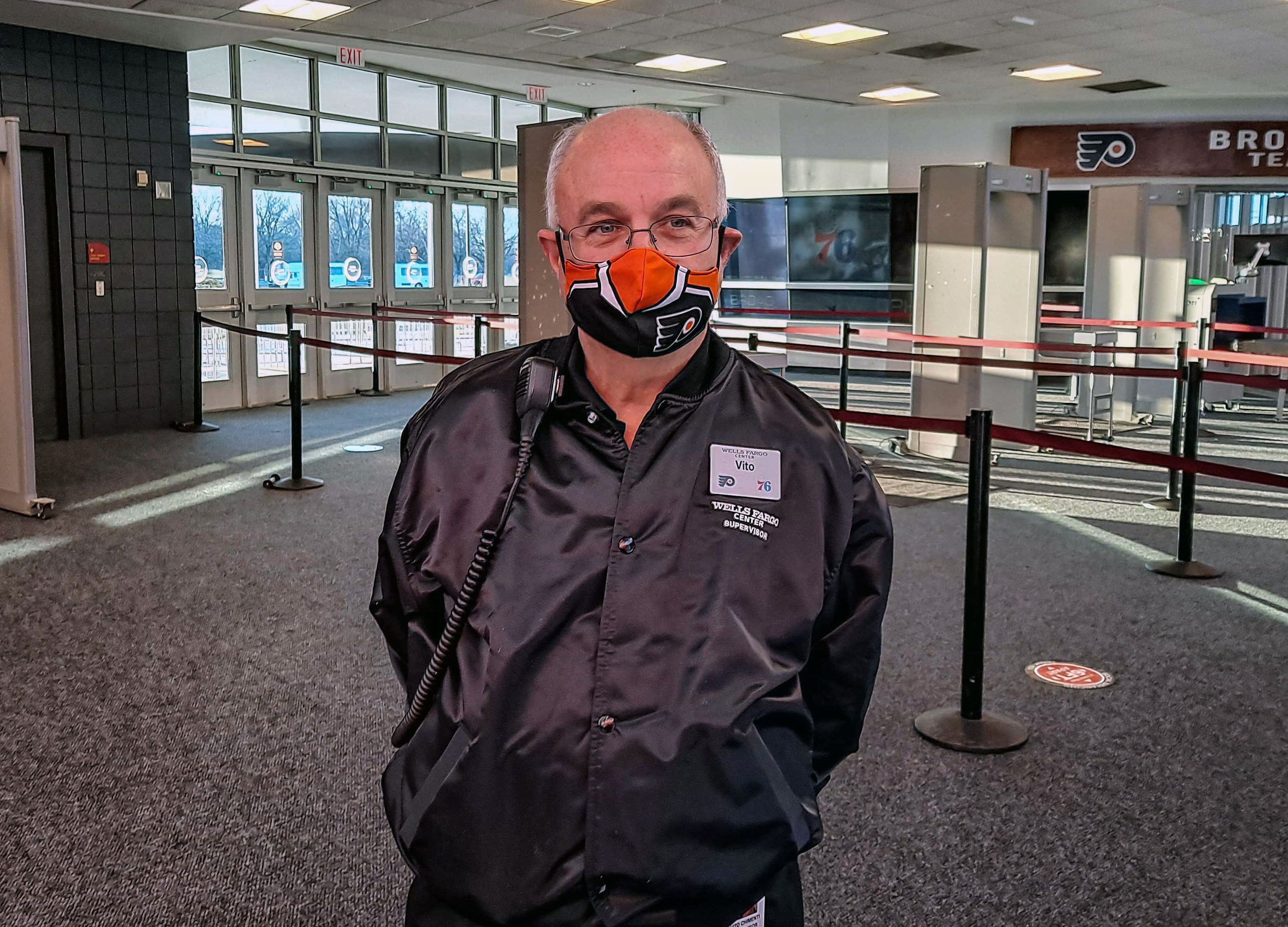 Vito Chimenti, wearing a face mask, stands inside Wells Fargo Center