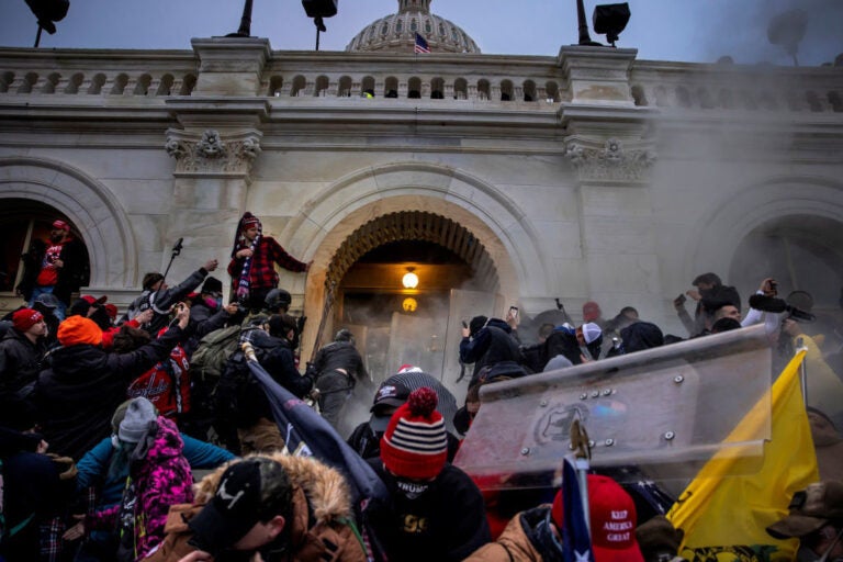 Pro-Trump rioters clash with police and security forces as people storm the U.S. Capitol on Jan. 6. Federal investigators say they expect even more people will be charged in connection with the insurrection. (Brent Stirton/Getty Images)