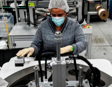 An employee makes respiratory masks in a family-owned medical equipment factory