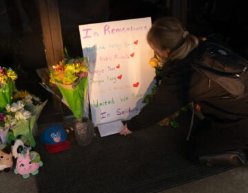 Flowers and signs adorn Gold Spa during a demonstration protesting violence against women and Asians following Tuesday night's shooting in the Atlanta area which killed eight. (Megan Varner/Getty Images)