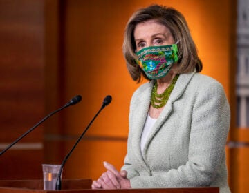 House Speaker Nancy addresses reporters from a podium