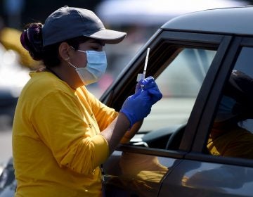 A worker prepares to give a COVID-19 vaccine at the Dignity Health Sports Park