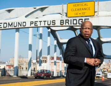 John Lewis stands on the Edmund Pettus Bridge