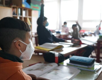 Third grade children attend school while wearing face masks