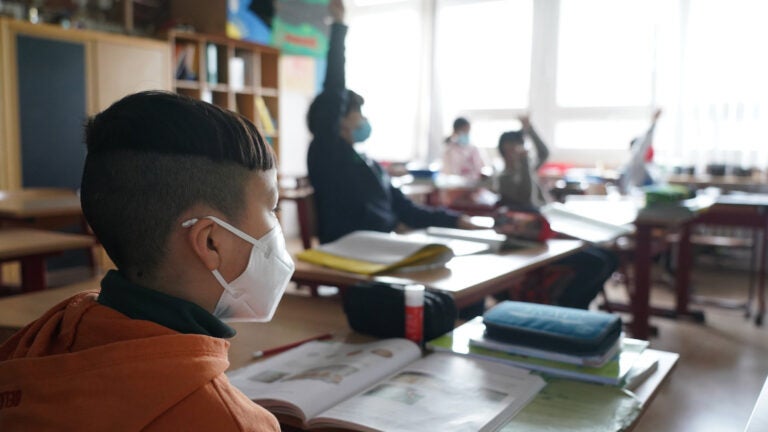 Third grade children attend school while wearing face masks