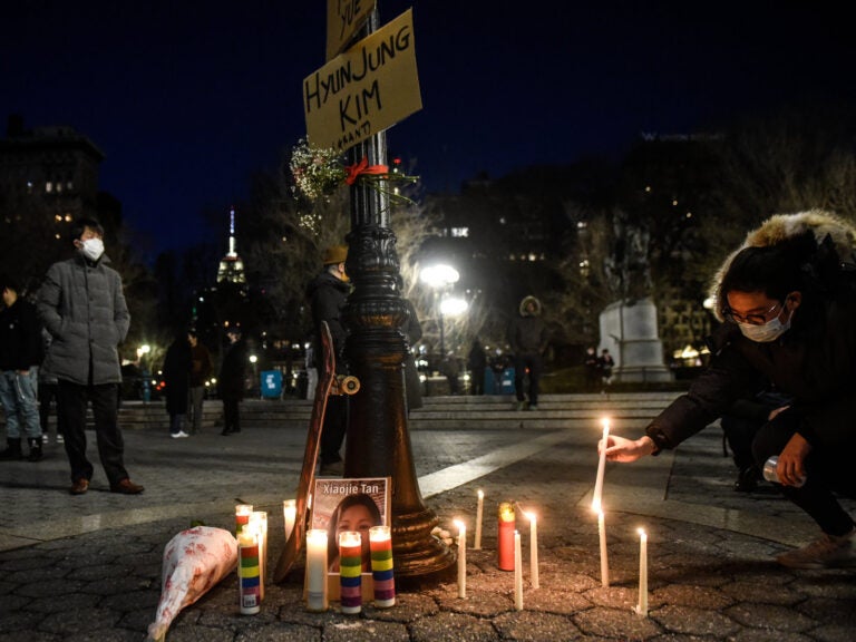 Peace Vigil Held In New York City For Victims Of Asian Hate A person lights candles during a peace vigil to honor victims of attacks on Asian Americans