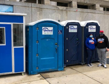 One Day At A Time's Terry Wagner and John Smutnik staff the trio of porta-potties at their new 15th and Arch location. (Michaela Winberg/Billy Penn)