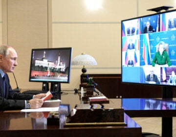 Russian President Vladimir Putin looks on at a Zoom meeting