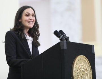 Rachel Wainer Apter speaks from a podium at Ruth Bader Ginsburg Hall