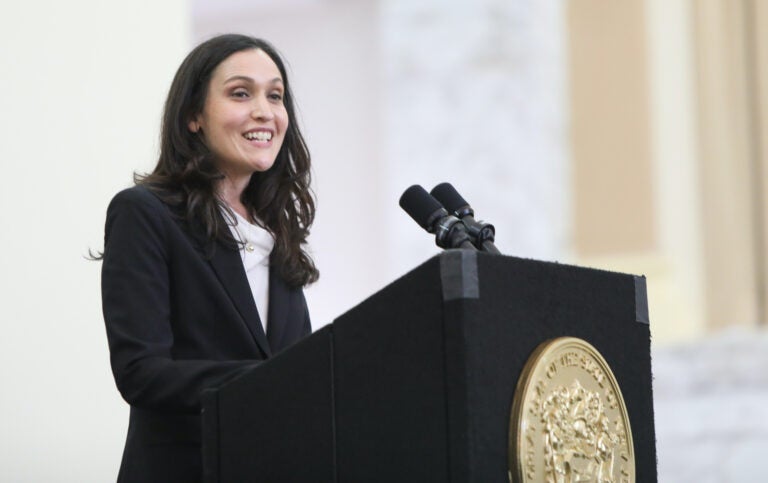 Rachel Wainer Apter speaks from a podium at Ruth Bader Ginsburg Hall