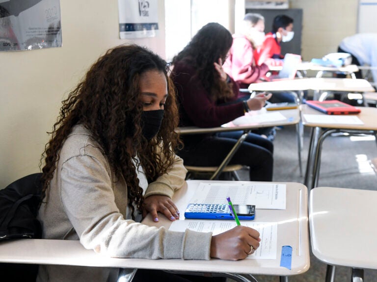 Giani Clarke, 18, a senior at Wilson High School in West Lawn, Pa., takes a test in her AP statistics class earlier this month. The desks are doubled as a way to provide more social distancing. (MediaNews Group/Reading Eagle vi/MediaNews Group via Getty Images)
