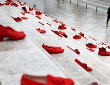 The red shoes are part of a public art installation denouncing violence against women. The photo was taken at Durresi main square in Tirana, Albania, on March 8 — International Women's Day. (Gent Shkullaku/AFP via Getty Images)