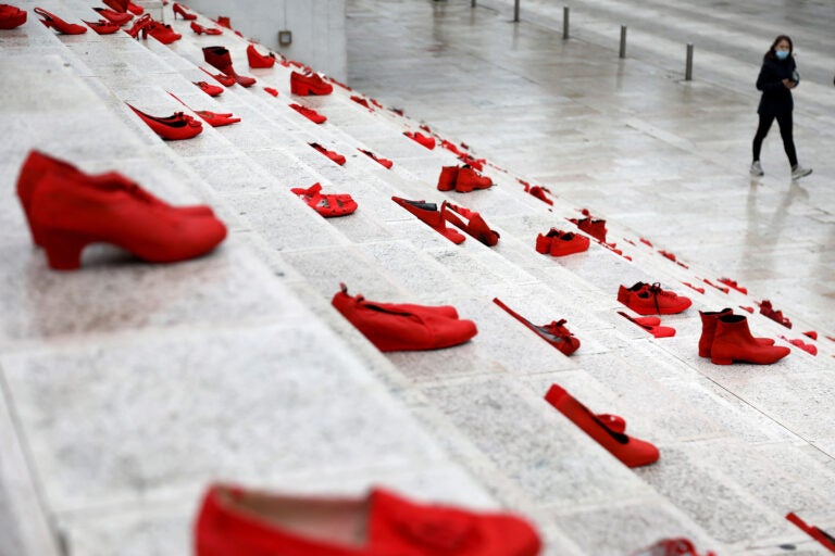 The red shoes are part of a public art installation denouncing violence against women. The photo was taken at Durresi main square in Tirana, Albania, on March 8 — International Women's Day. (Gent Shkullaku/AFP via Getty Images)