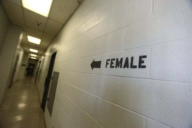 A sign points toward the women's section of the Huntington Beach jail